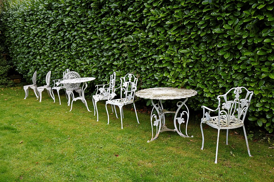 Cast iron garden tables and chairs at Nuthurst, West Sussex, England.Software: RAW file lens-corrected, optimized and converted to JPEG with DxO OpticsPro 10 Elite, and likely further optimized and/or cropped and/or spun with Adobe Photoshop CS2.